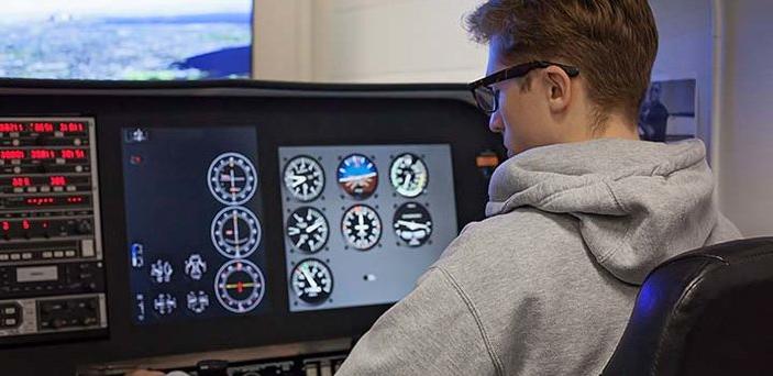 Aviation student operates a flight simulator